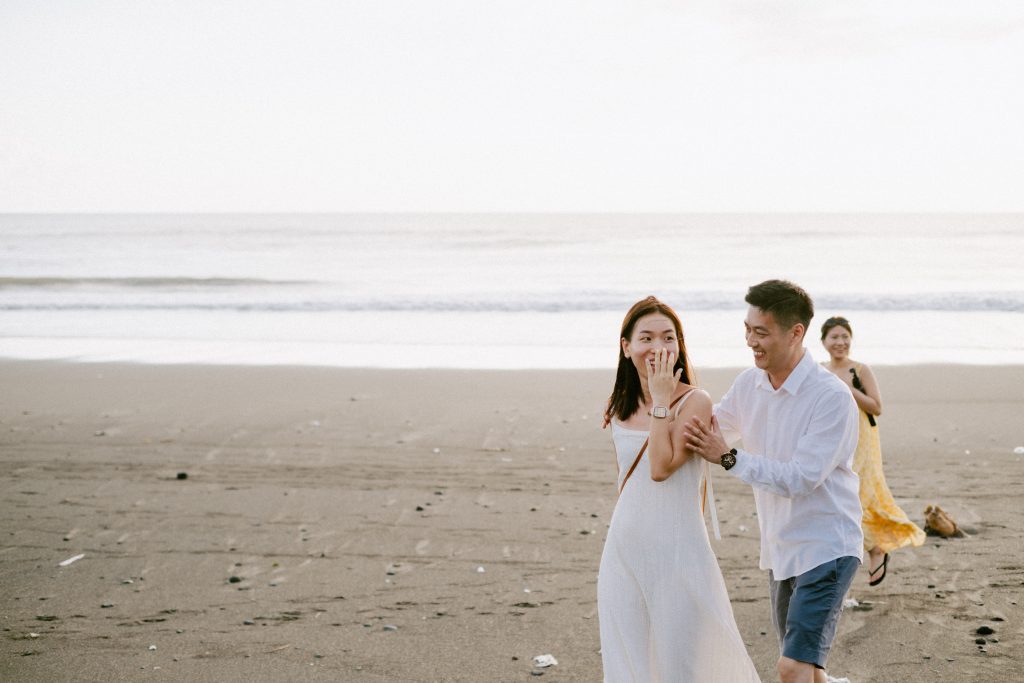 Bride's emotional reaction as she discovers her surprise proposal decoration on a Bali beach.